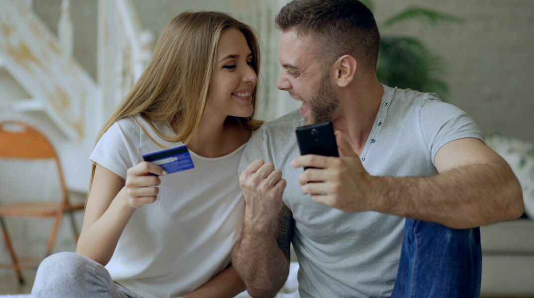 Young Singaporean couple discussing finances on a laptop at home